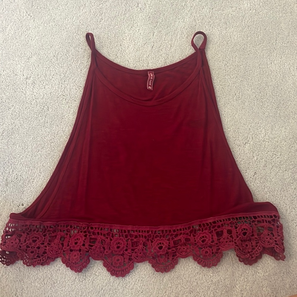 Dark plum cropped top with open sides and crochet bottom.